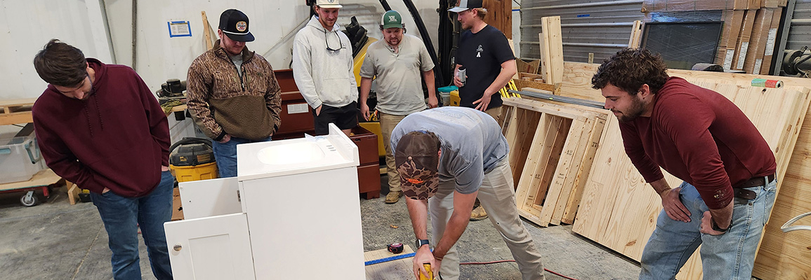 Student working on cabinet