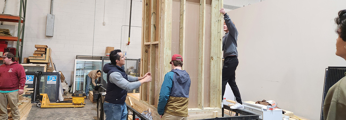 Students building wooden structure