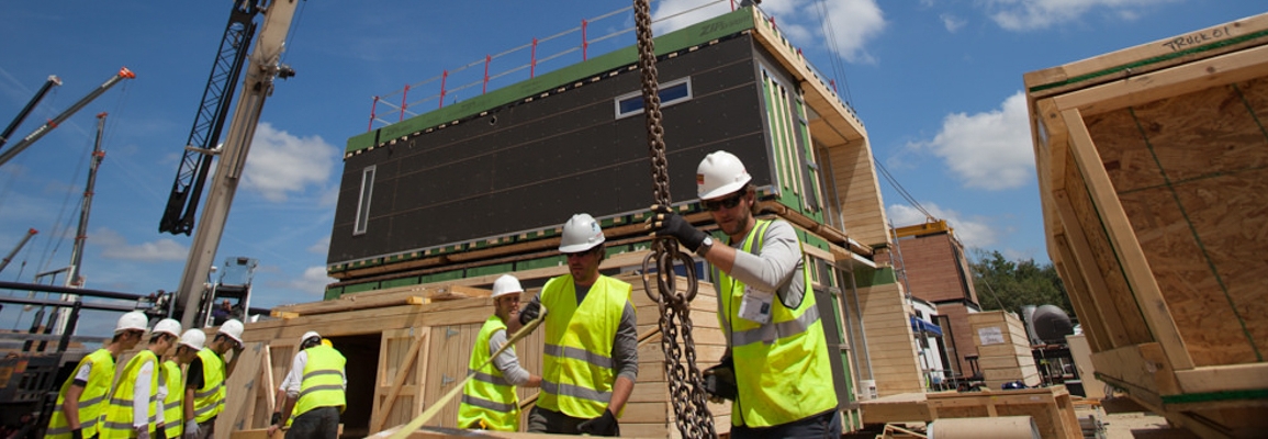 students constructing sustainable housing for competition