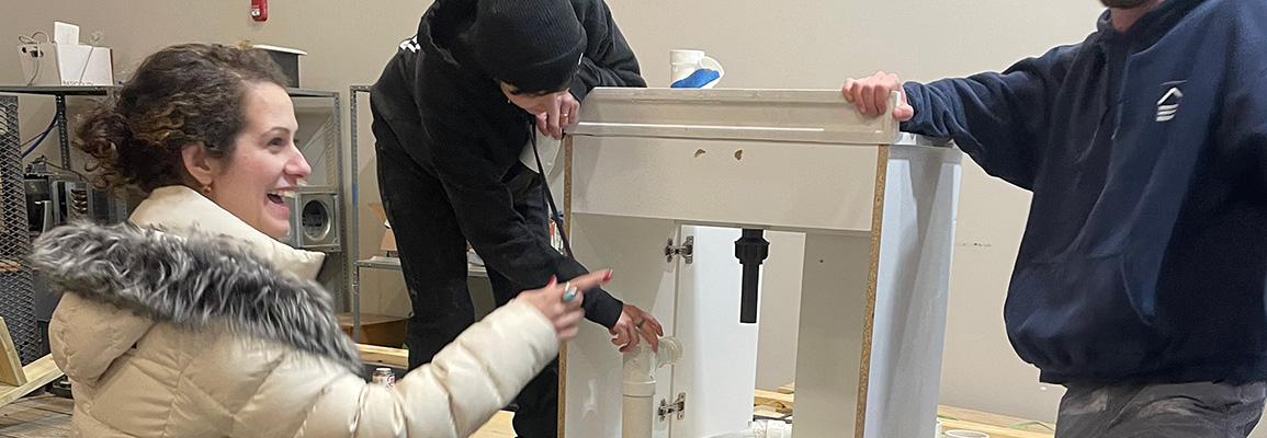 Students working on cabinet
