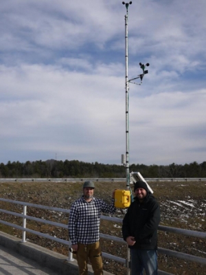 Brent Summerville and Robb O'Brien install a wind measurement system