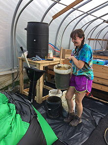 Gabbie Batzko loading the digester